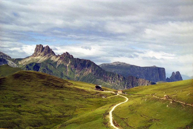 Mountain trail across the Alpe di Siusi below distinctive Dolomite peaks